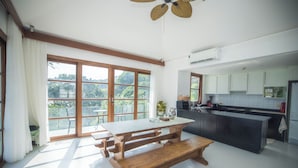 A spacious kitchen with a large island, wooden bench, and a dining table. - Koh Samui frontline sea view 5-bedroom (Koh Samui)
