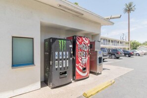 A building with a vending machine and a Coca-Cola vending machine.