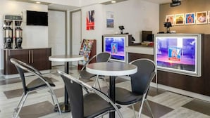 A modern hotel lobby with a reception desk, seating area, and a coffee machine. - 2 Queen Beds | Non-Smoking, Kitchen (Fresno CA)
