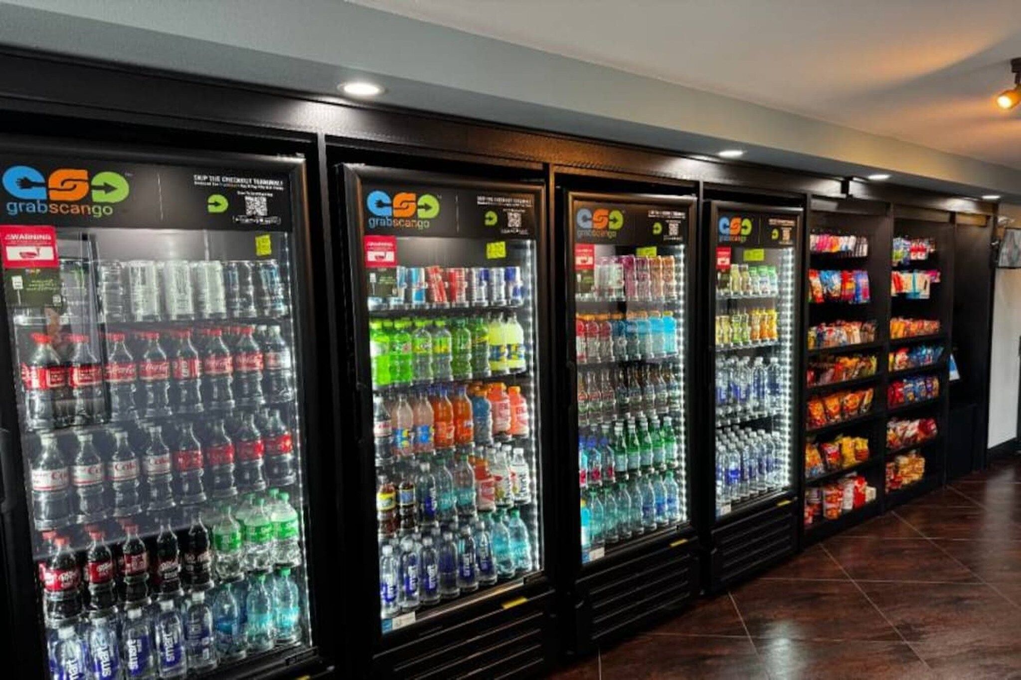 A row of vending machines stocked with various beverages and snacks.