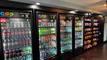 A row of vending machines stocked with various beverages and snacks.