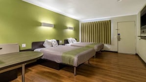 A hotel room with two beds, a desk, and a door. - Redlands, Ca 2 QUEEN BEDS | SMK (REDLANDS)