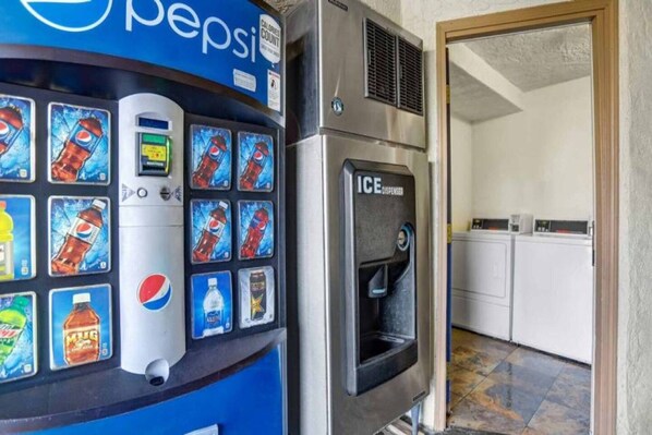 A vending machine with various beverage options and an ice dispenser.