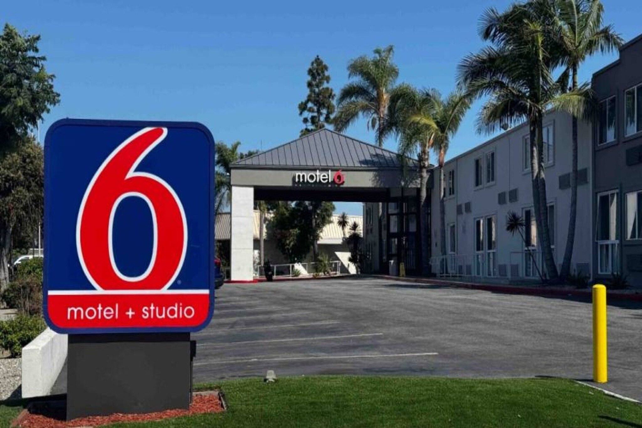 A motel entrance with a prominent sign indicating it is number 6.