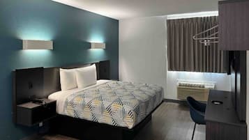 A modern bedroom with a bed, bedside tables, a desk, and a window with curtains.