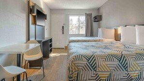 A hotel room with a bed, a desk, a chair, a television, and a window. - 2 Full Beds | Non-Smoking, Kitchen (Hayward)