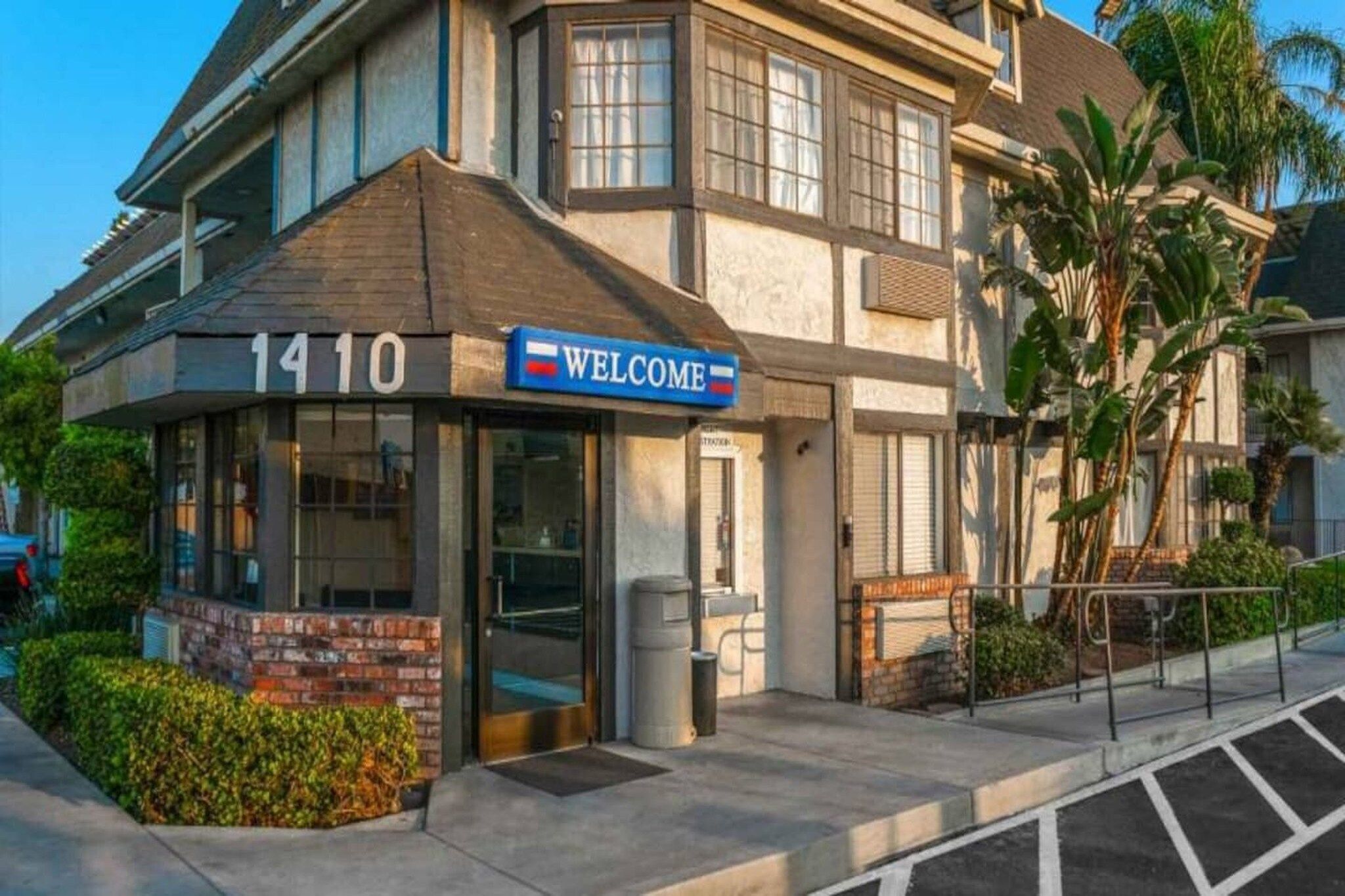 A building with a 'WELCOME' sign and the number '1410' above the entrance.