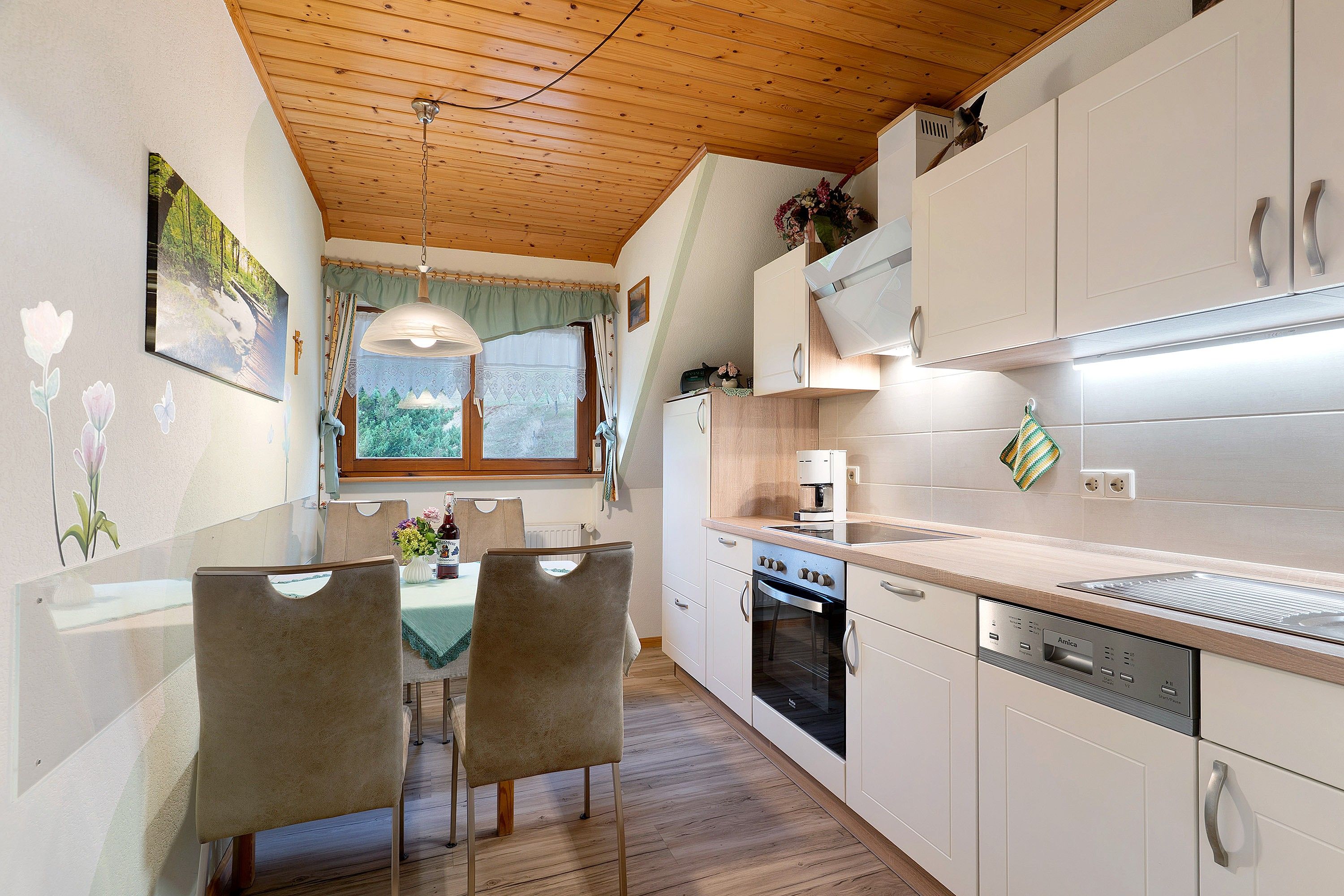 A modern kitchen with wooden cabinets, a built-in oven, and a dishwasher.