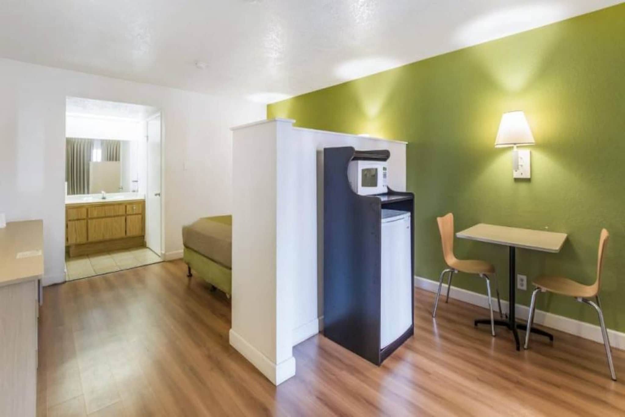 A compact living space with a kitchenette, a dining area, and a separate sleeping area.