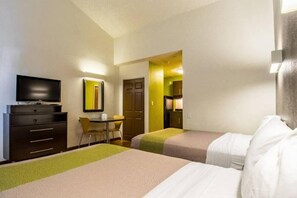 A hotel room with two beds, a desk, a chair, a television, and a mirror. - 2 Full Beds|NS| Kitchen (Cypress)