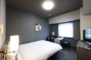A hotel room with a bed, a desk, a chair, a television, and a window with curtains. - HotelRouteInnKobesanda-ShinSandaEkimae- (Sanda)