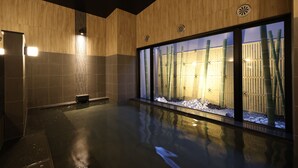 A modern bathroom with a large glass window, a bamboo plant, and a small bench. - HotelRouteInnKobesanda-ShinSandaEkimae- (Sanda)