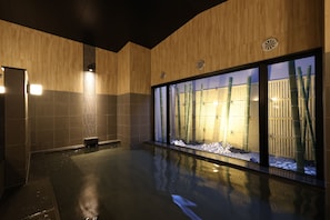 A modern bathroom with a large glass window, a bamboo plant, and a small bench. - HotelRouteInnKobesanda-ShinSandaEkimae- (Sanda)