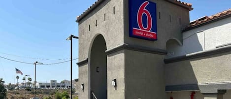 A building with a prominent '6' sign indicating a hotel and studio.