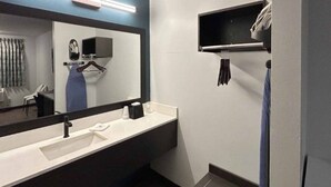 A modern bathroom with a large mirror, a sink, and a towel rack. - 1 King Bed | Non-Smoking, Micfridge (Lake Elsinore)