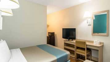 A hotel room with a bed, a desk, a television, and a chair.