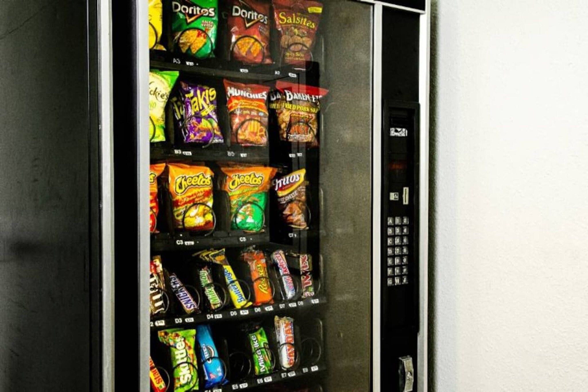 A vending machine stocked with various snack brands.