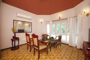 Una habitación con suelo estampado, muebles de madera, un espejo grande y una ventana con cortinas.