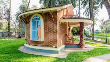 Un petit bâtiment en briques, doté d’un toit incurvé et d’une grande fenêtre en arc de cercle.