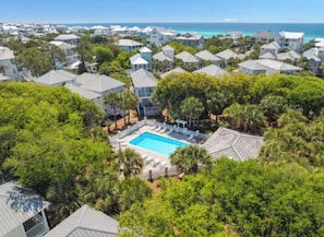 A residential area with multiple houses, a swimming pool, and a view of the ocean. - Cozy 2-bedroom house in pleasant Santa Rosa Beach with AC (Santa Rosa Beach)