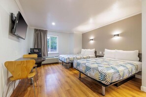 A hotel room with two beds, a desk, a chair, a television, and a window. - 2 Full Beds | Non-Smoking, Micfridge (Auburn)