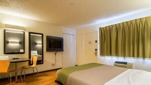 A hotel room with a bed, a desk with a chair, a television, and a window with curtains. - 1 King Bed|Mobil Access Tub NS Kitchen (Cypress)