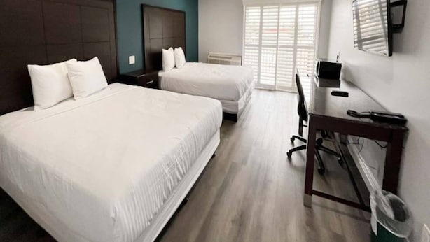 A hotel room with two beds, a desk, and a chair. - Spacious 2 Queen Beds | Nsmk, Micfridge (Vallejo)