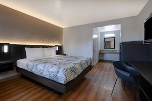 A hotel room with a bed, a desk, and a bathroom. - Premium Queen Bed|Pool|Free Parking (Buttonwillow)