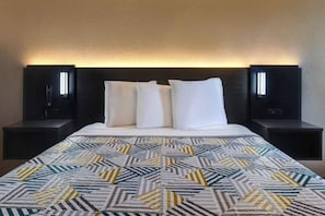 A hotel room with a bed, two bedside tables, and a headboard with integrated lighting. - 1 King Bed | Non-Smoking, Micfridge (Buttonwillow)
