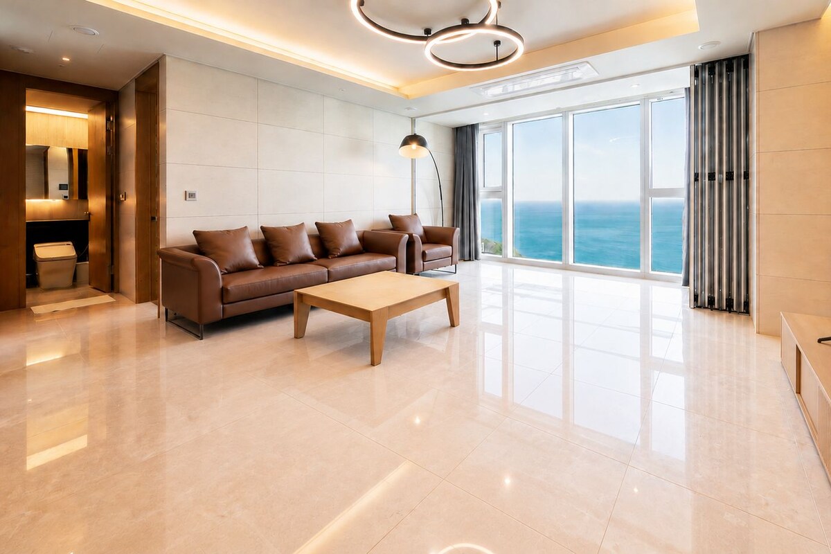 A modern living room with a sofa, coffee table, and a television.