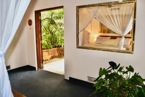 A room with a bed, a window with a view of greenery, a potted plant, and a door leading outside. - Salty's Kitesurf Village (Kilifi)