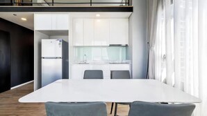A modern kitchen with white cabinets and a built-in refrigerator. - Siamese Residence Rama 9 Bangkok (Krung Thep Maha Nakhon)