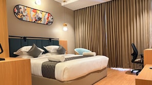 A modern hotel room with a large bed, a desk, a chair, a headboard, a wall art piece, and a curtain. - Snooz Rooms By Parika A VYDA Hotel (Bengaluru)