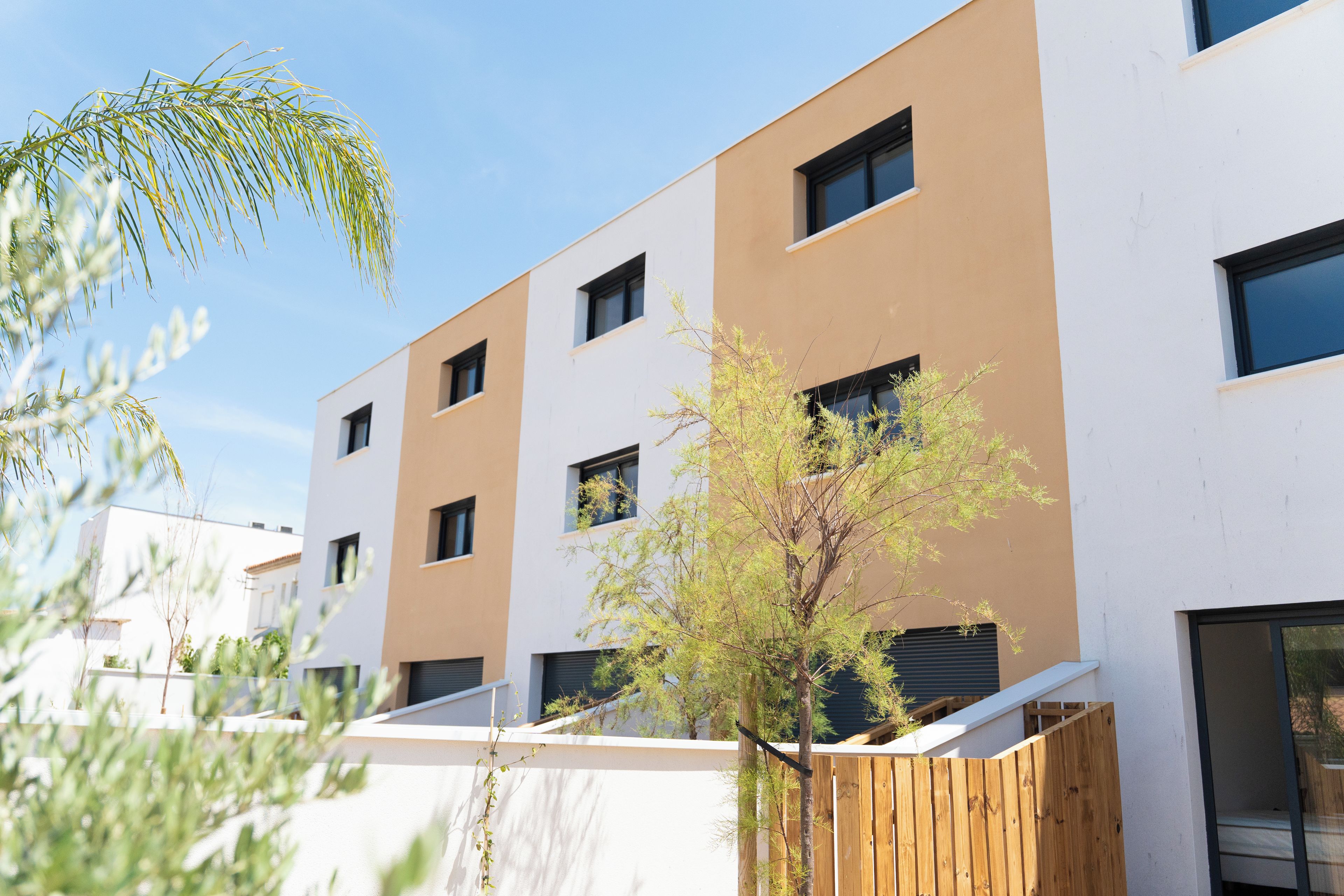 A modern building with multiple windows and a flat roof.