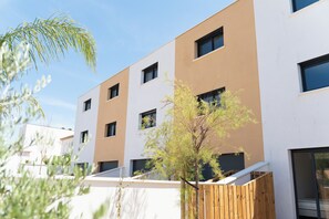 A modern building with multiple windows and a flat roof.
