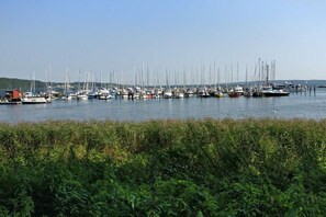 A marina with numerous boats docked, surrounded by greenery. - Holiday apartment in Harrislee with Wi-Fi (Harrislee)