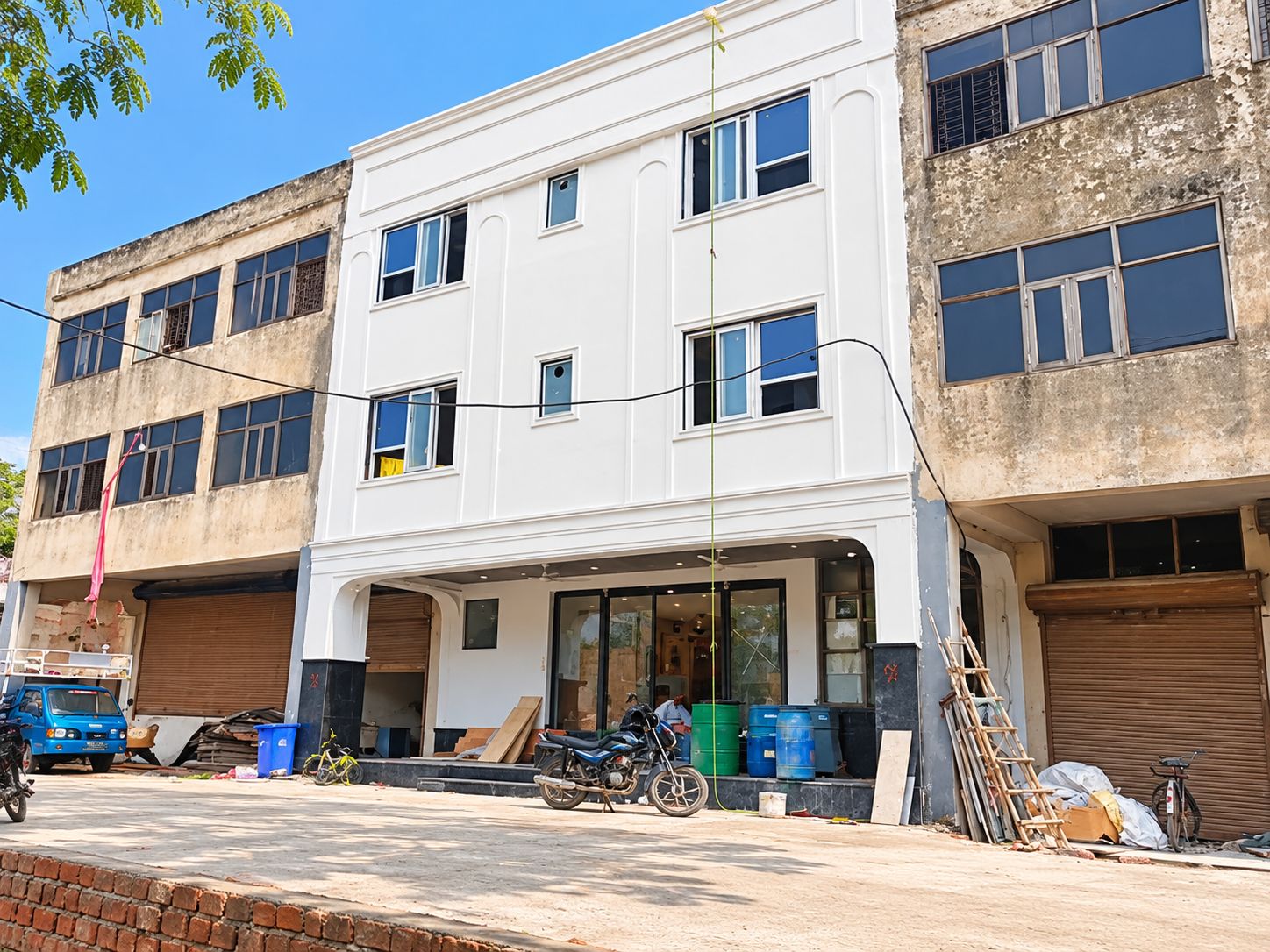 A two-story building with a flat facade, large windows, and a visible ground floor entrance.
