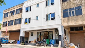A two-story building with a flat facade, large windows, and a visible ground floor entrance.