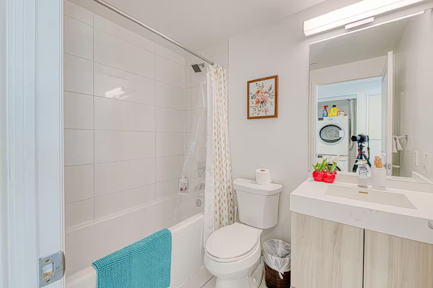 A modern bathroom with a shower, toilet, and sink area.