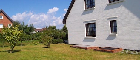 A modern two-story building with a flat roof and white exterior walls.