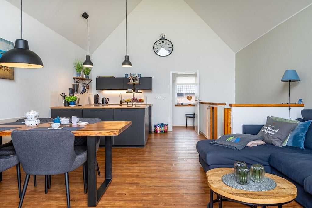A modern interior with a dining area, kitchen, and living space.