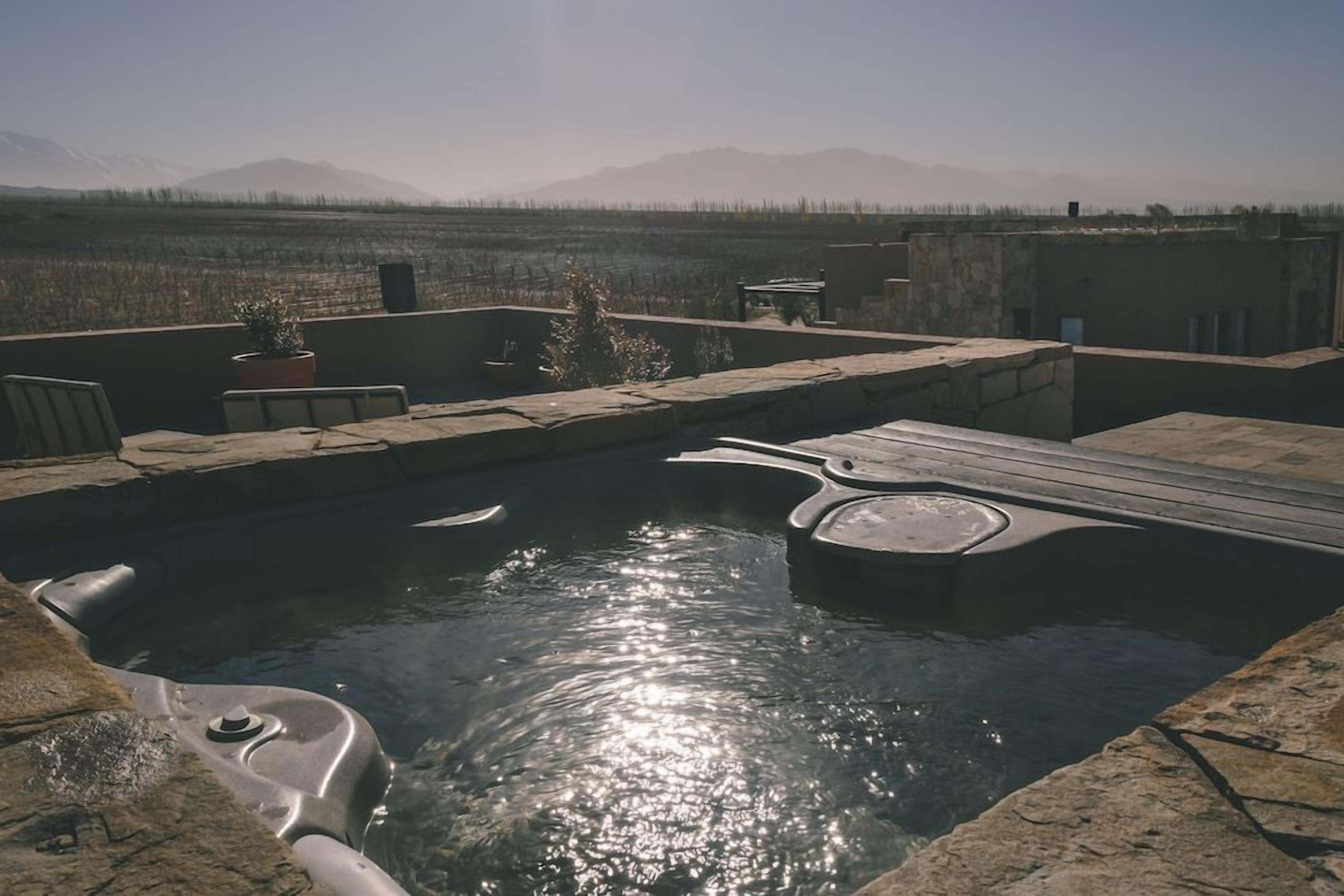 A hot tub with a view of mountains in the background.