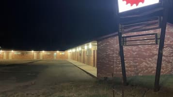 A building with a sign for Sawmill Rentals, featuring a brick facade and a parking lot.