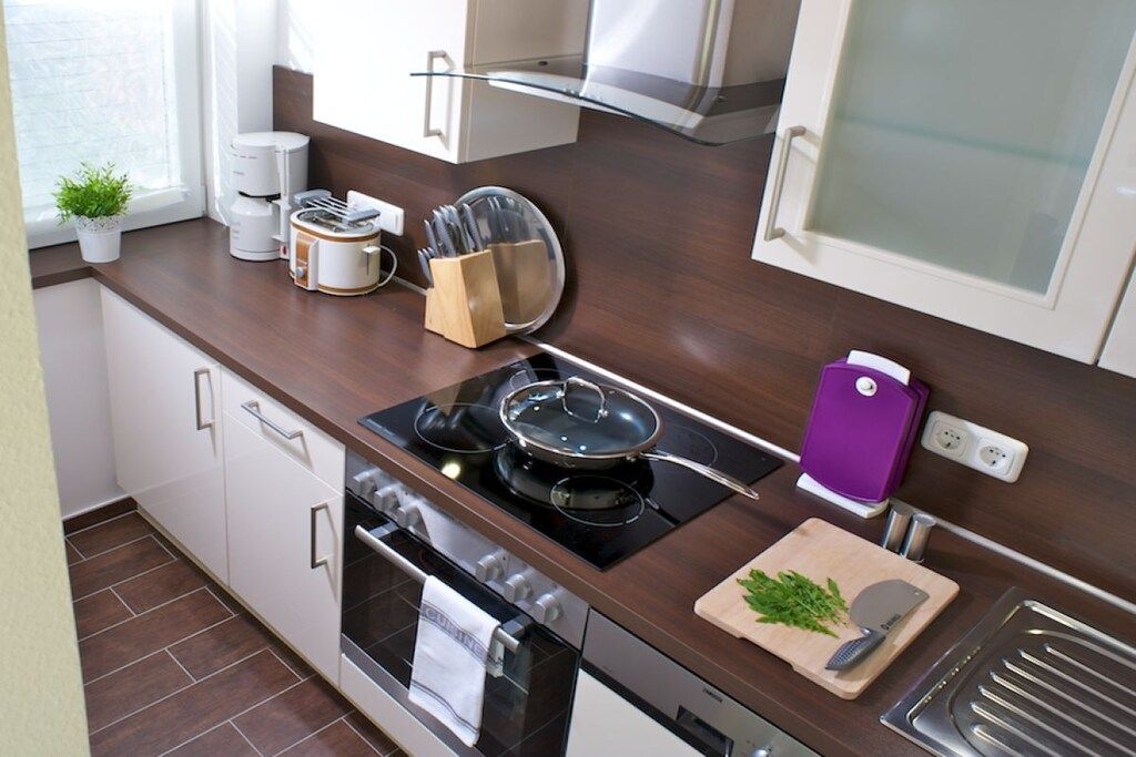 A modern kitchen with a stove, oven, and various appliances.
