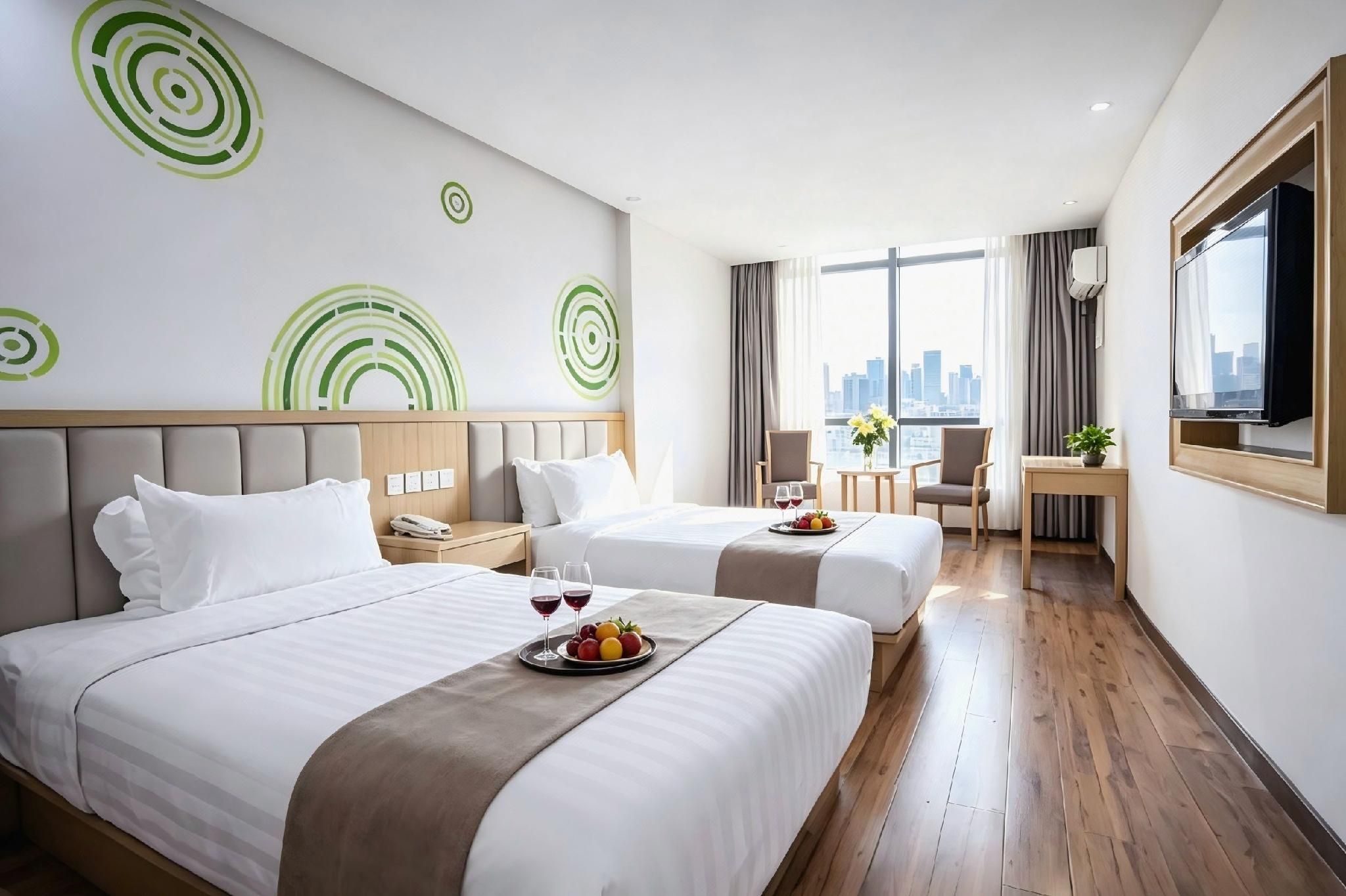 A hotel room with two beds, a desk, a chair, and a city view.