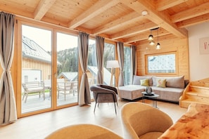 A wooden interior with a sofa, chairs, and a table. - Cabin in Niederwölz with sauna (Niederwölz)