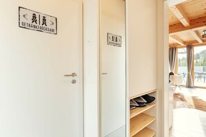 A hotel room with a wooden ceiling, a sliding door with a sign, and a view of the outdoors. - Chalet #1 with 2 bedrooms and sauna (Niederwölz)