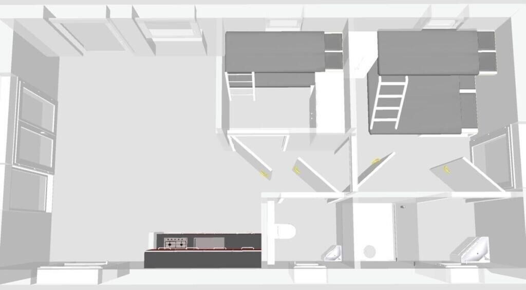 A floor plan of a hotel room with a bed, a desk, a chair, a wardrobe, and a bathroom.
