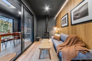 A modern interior with a sofa, a table, and a fireplace.