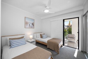 A hotel room with two beds, a ceiling fan, a window with a view, and a door leading to an outdoor area. - Poolside 3-Bed Retreat Near Kings Beach (Kings Beach)